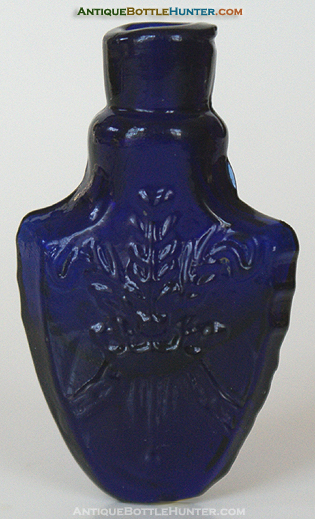 A deep purplish cobalt blue mold blown shield shaped smelling bottle --- AntiqueBottleHunter.com