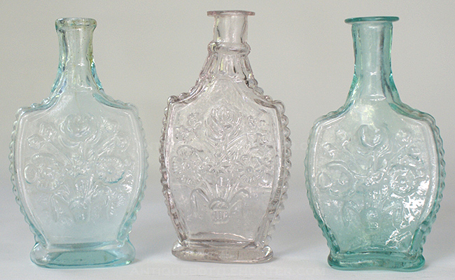 Three very similar colognes referred to as the 'Floral Spray'. (4 - 3/8 in., 4 - 3/8 in. and 4 - 1/4 in.) --- AntiqueBottleHunter.com