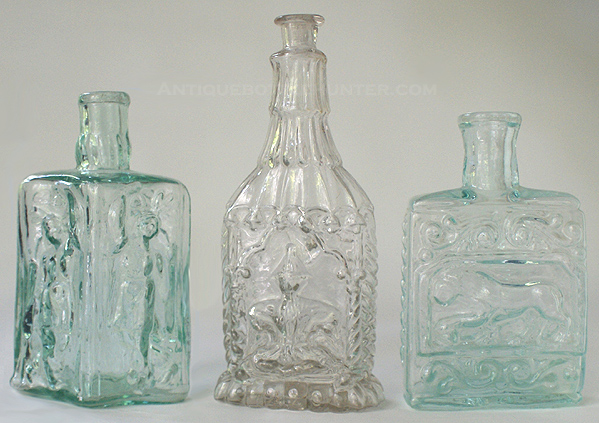 A diamond shaped aquamarine 'Pocahontas' also known as the 'Dancing Indian' (4 - 7/8 in.) - A colorless 'Buddha' (6 in.) - A rectangular aquamarine 'Lion' (4 - 1/2 in.) --- AntiqueBottleHunter.com