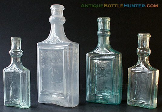 Four framed label only colognes with bulbous necks... or are they? --- AntiqueBottleHunter.com