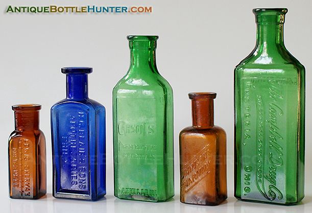 An amber LEWIS SHERMAN, a blue H.C. BLAIR'S SONS, a yellow green CARSON'S, an amber JOHNSON'S PHARMACY and a yellow green CAMPBELL DRUG CO. --- Antiquebottlehunter.com