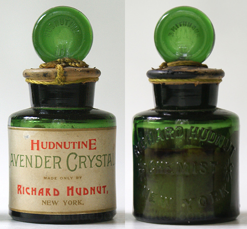 A light yellow green cylinder shaped bottle embossed: RICHARD HUDNUT / (Fleur de lis) CHEMIST (Fleur de lis) / NEW YORK. Stopper: HUDNUTINE in an arc over a H. Label reads as shown in picture. It still contains it's contents, is sealed with wax and has a green string at stopper. The base has a golden label with trade mark name and large bird. Height w/out stopper, 2 - 3/4 in. Width, 2 in. --- AntiqueBottleHunter.com