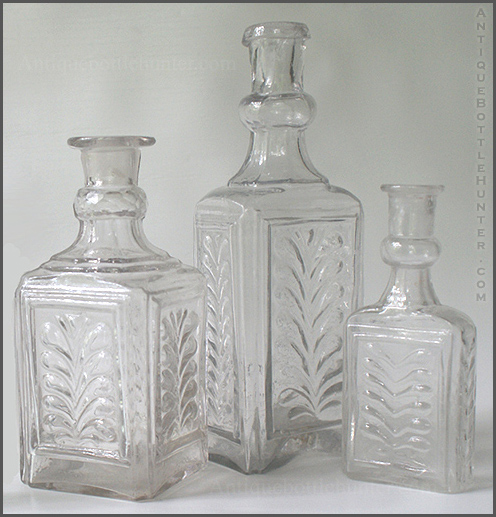 A group of three early colorless colognes with plumes. --- AntiqueBottleHunter.com