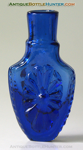A medium electric blue shield shaped sunburst smelling bottle --- AntiqueBottleHunter.com