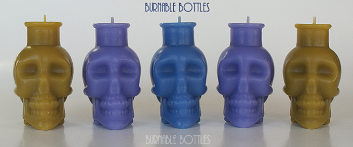 A group of skull bottle candles --- Burnable Bottles - AntiqueBottleHunter.com