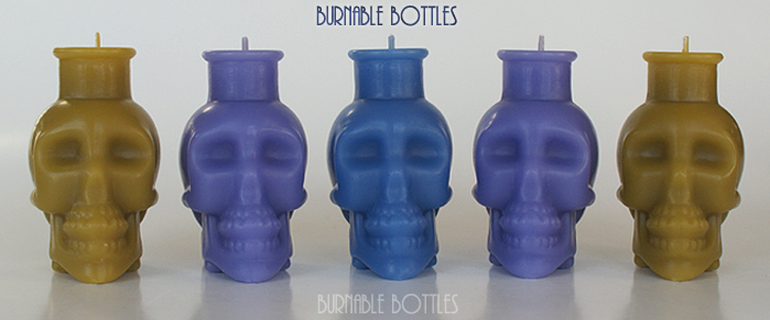 A group of skull bottle candles --- Burnable Bottles - AntiqueBottleHunter.com