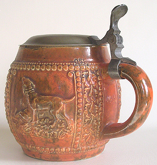 An old bulbous shaped pewter lidded stien from Germany with hunting scene including dogs